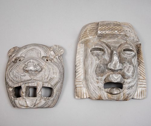 Lote de 2 máscaras. México. Siglo XX. Tallas en piedra. Consta de: Jaguar y Maya.