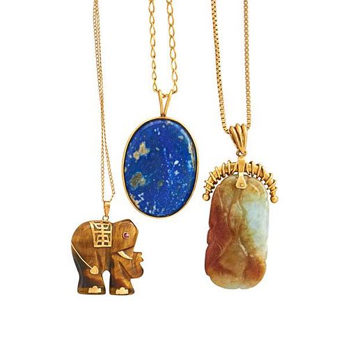 THREE YELLOW GOLD AND CARVED HARDSTONE PENDANTS