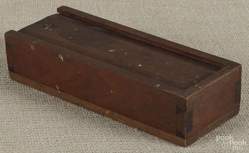 Pennsylvania walnut slide lid pencil box, 19th c., 1 3/4'' h., 8'' w., 3'' d.