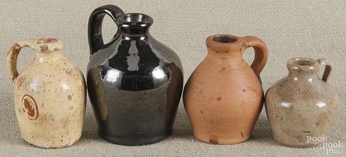 Four miniature Pennsylvania redware jugs, 19th c., largest - 4 1/4'' h.