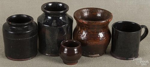 Five pieces of assorted Pennsylvania redware, 19th/20th c., to include a vase, two jars