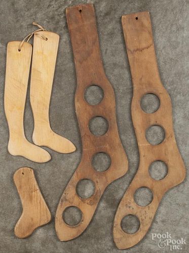 Two pairs of wooden sock stretchers, 19th c., together with a child's sock stretcher.