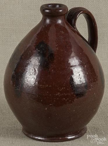 Pennsylvania redware jug, 19th c., 9'' h.