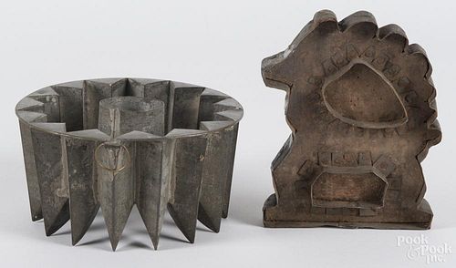 Tin food mold, 19th c., 3 3/4'' h., 7 1/4'' w., together with a cookie cutter, 7'' h., 5 1/2'' w.