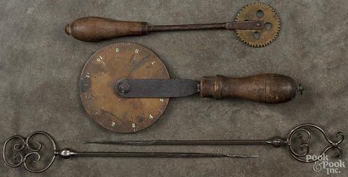 Two wrought iron skewers, 11'' l., together with a jagging wheel and a copper traveler.