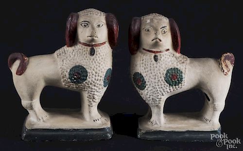 Pair of Pennsylvania chalkware spaniels, 19th c., both retaining a later decorated surface, 7'' h.