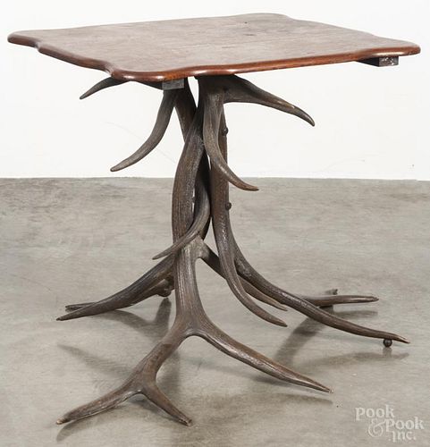 Oak top table with an antler base, 20th c., 28 1/2'' h., 28'' w.