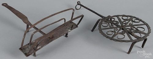 Two wrought iron kitchen utensils, 19th c., to include a toaster, 14 3/4'' l., and a rotating trivet