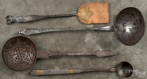 Four wrought iron utensils, 19th/20th c., two with later brass inlay.