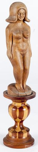 Folk art carved figure of a nude woman, early 20th c., mounted on a parquetry base, 17'' h.