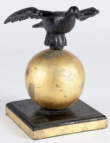 Cast iron eagle, ca. 1900, mounted atop a giltwood sphere, 13 1/4'' h.