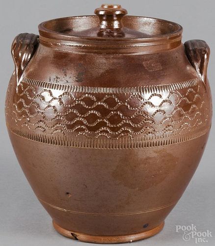 American stoneware lidded jar, 19th c., with incised coggled bands, 9 1/2'' h.