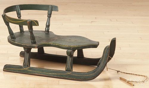 Painted child's sled, 19th c., retaining its original green surface with a yellow pinstripe, 15'' h.