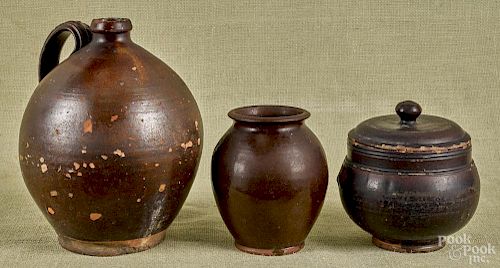 Three Pennsylvania redware vessels, 19th c., to include a covered jar, incised 33 on lid and base