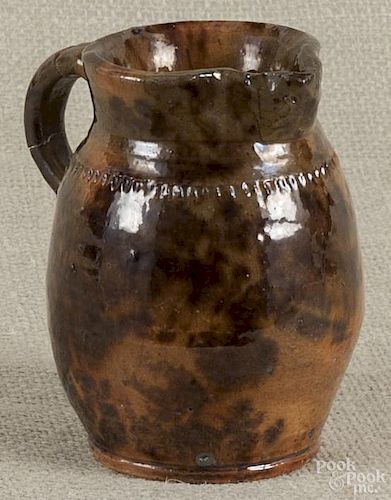 Pennsylvania redware pitcher, late 19th c., attributed to Jacob Medinger, 4 5/8'' h.