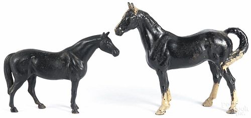 Two painted cast iron horse doorstops, ca. 1900, 7 1/2'' h. and 10'' h.