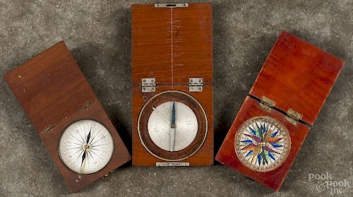 Three small compasses, ca. 1900, the largest signed Queen & Co. Philada., all in wood cases.