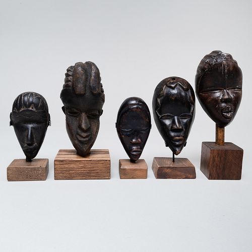 Group of Twenty-One African Wood Passport Masks
