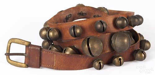 Set of brass sleigh bells, ca. 1900, largest bell is no. 8, overall - 79'' l.
