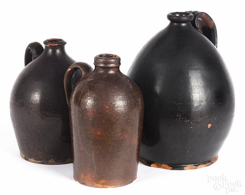Three New England redware jugs, 19th c., 10'' h., 8'' h., and 8'' h.
