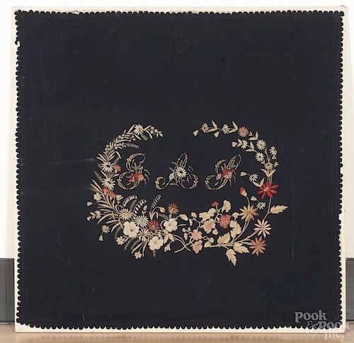 Large framed wool embroidered panel, late 19th c., with a monogram within a floral wreath, 55'' x 55''