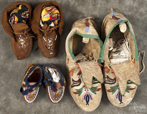 Three pairs of Native American beaded moccasins, mid 20th c., 11'' l., 7'' l., and 5'' l.