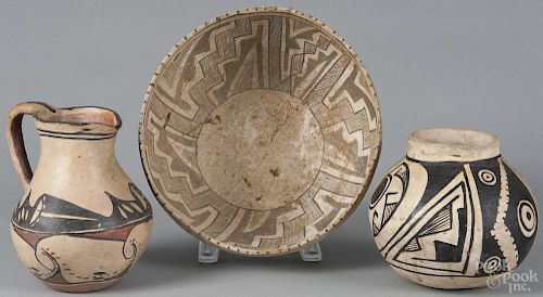 Acoma pitcher, early 20th c., 6 3/4'' h., together with a Zia bowl and a small pot.