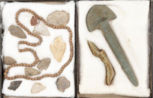 Two shadowboxes of Native American stone implements and a pottery bead necklace.