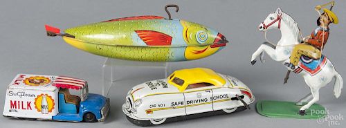 Four tin wind-up toys, to include Chein fish, Keim cowboy, a Sunflower Milk truck
