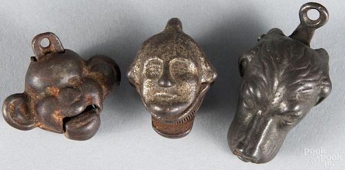 Three cast iron cap bombs, to include George Washington Yellow Boy and a hound.