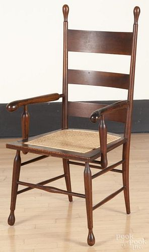 Oak ladderback armchair, late 19th c., with a cane seat.