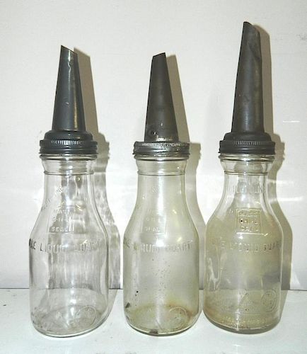 Oil - 3 clear bottles with metal funnel tops