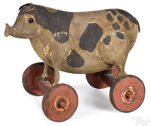 Folk art carved and painted pig pull toy