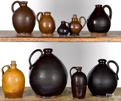 Nine assorted redware jugs, 19th c.