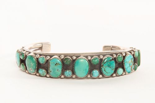 A Navajo Turquoise and Silver Row Bracelet