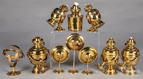 Six gimbaled brass fluid lamps.