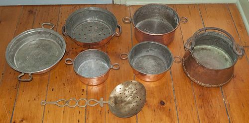 Group of copper and brass cookware.