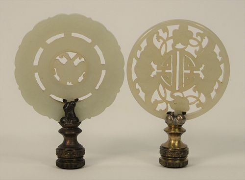 Two Jade Discs made into Lamp Finials, one having double surround with central movable mount (white - light green), and one having r...