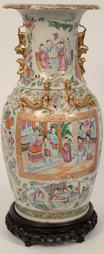 Rose Medallion Vase, porcelain having enamel painted courtyard scenes, molded foo dog handles and gilt dragons, 19th century on carv...