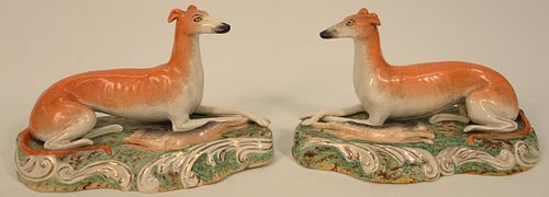 Pair of Staffordshire Whippet each molded as opposing recumbent figures beside hare.
height 6 1/2 inches, length 11 inches.