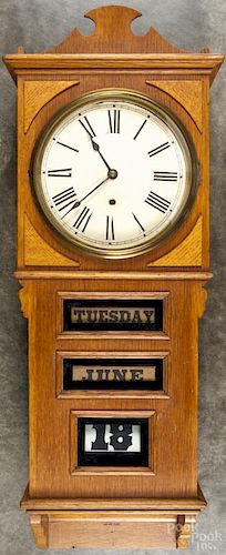 Prentiss Clock Improvement Co. oak calendar wall clock, 36 1/2'' h.