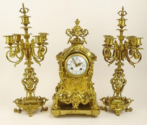 Three (3) piece French ormolu bronze clock garniture set.