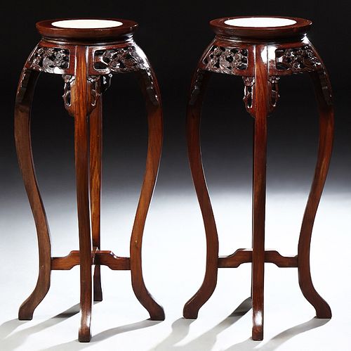 Pair of Chinese Carved Mahogany Marble Top Pedestals, 20th c., the inset circular marble over a pierced skirt with bird and floral d...