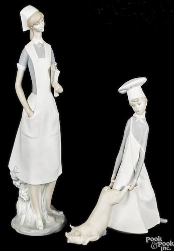 Two Lladro porcelain figures, to include a nurse, 14'' h., and a boy with a pig, 9 1/2'' h.