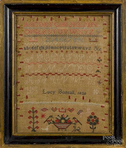 English wool on linen sampler, dated 1828, wrought by Lucy Bonsall, 14'' x 11''.