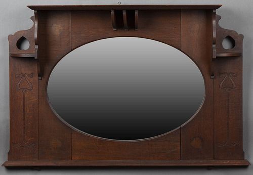 English Carved Oak Overmantle Mirror, early 20th c., with a center crown flanked by two small shelves over circular cutout backs, ab...