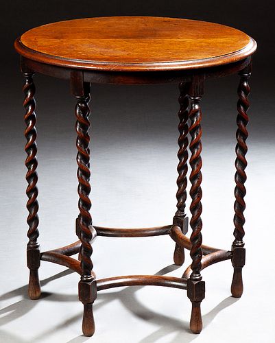 English Jacobean Style Carved Oak Lamp Table, early 20th c., the stepped circular top over a narrow skirt, on six slender rope twist...