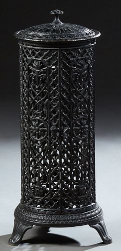 Continental Cast Iron Room Heater, late 19th c., of cylindrical form, with a pierced top and pierced floral and torch decorated side...