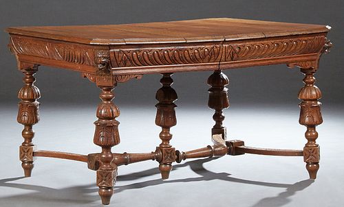 French Henri II Style Carved Oak Dining Table, late 19th c., the stepped canted corner top over a highly carved frieze, on ring and...