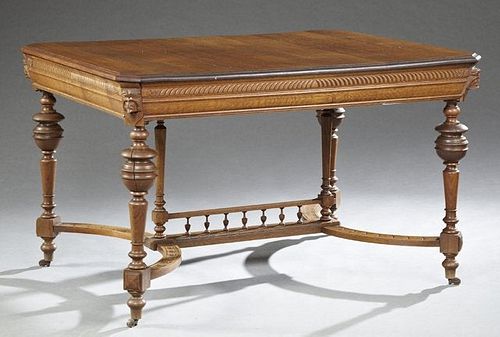 Henri II Style Carved Oak Dining Table, late 19th c., the stepped edge canted corner rectangular top, over a wide skirt on ring-turn...